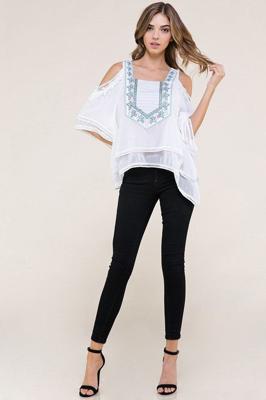 White fashion top with light blue and pink design