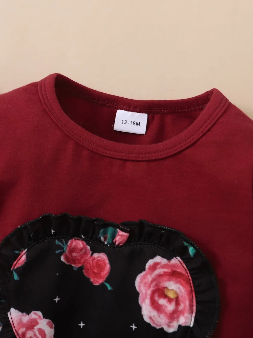Baby girl outfit set in maroon with floral print top, coordinating bottoms, and headband