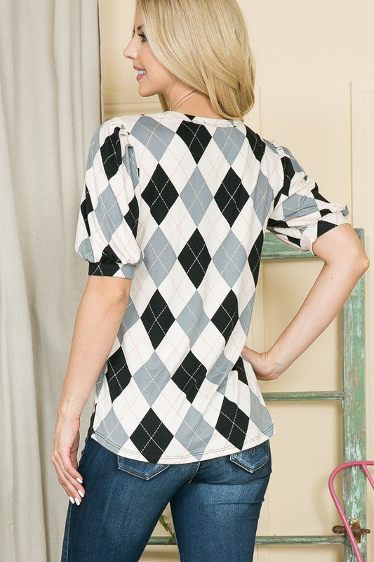 Eye-catching argyle texture and puffed sleeves make this piece a standout.