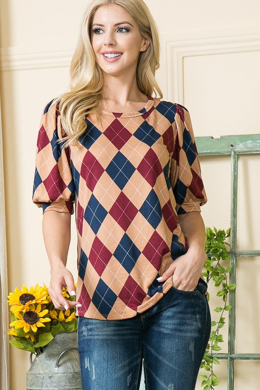 Comfortable knit body meets voluminous sleeves — argyle print adds visual interest.