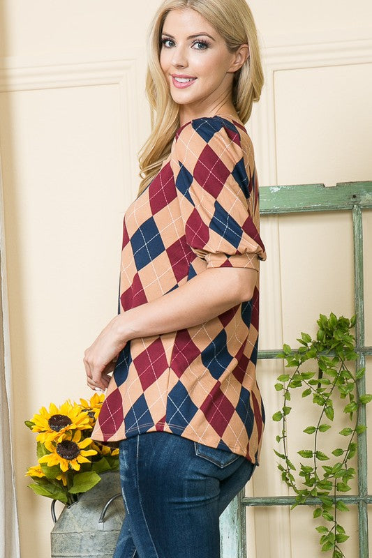 Stylish and statement-making: argyle pattern paired with puffed shoulder detail.