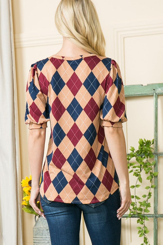 A flattering silhouette with puff sleeves and argyle contrast that elevates everyday wear.