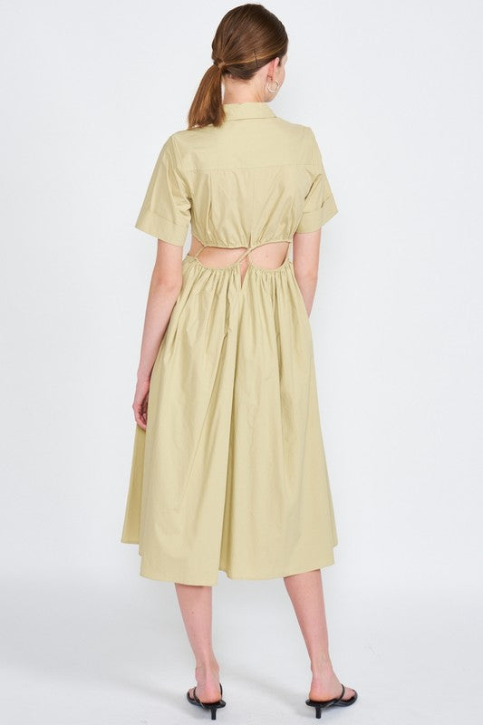 Woman models a stylish olive green midi dress with a collar, short sleeves, and fashionable cut-outs, back view.