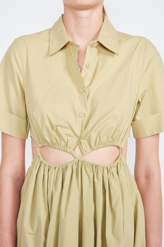 Woman models a stylish olive green midi dress with a collar, short sleeves, and fashionable cut-outs close up.