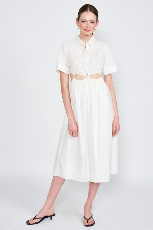 Woman models a white midi dress with a collar, short sleeves, and trendy cut-out details.