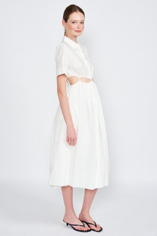 Woman models a white midi dress with a collar, short sleeves, and trendy side cut-out details, side view.