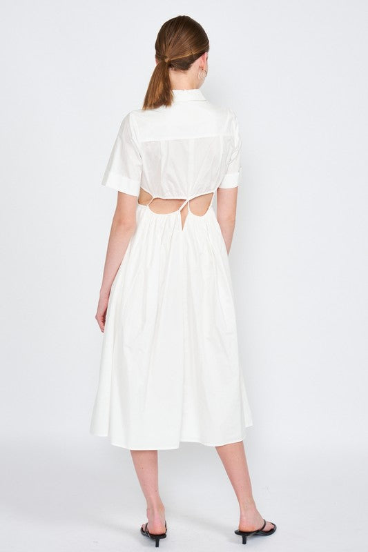 Woman models a white midi dress with a collar, short sleeves, and trendy cut-out details, back view.