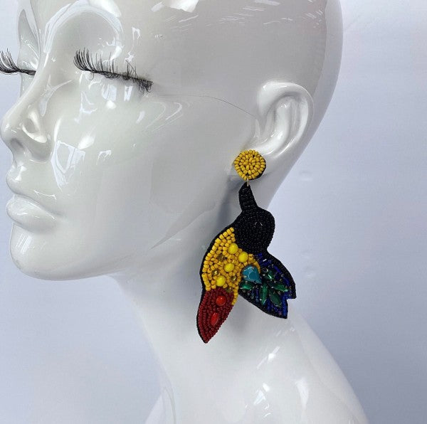 An image of a vibrant, multicolored statement earrings with a tropical-inspired design, bold, artistic, and perfect for adding flair to a casual look.