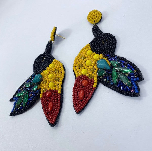 An image of a vibrant, multicolored statement earrings with a tropical-inspired design, bold, artistic, and perfect for adding flair to a casual look.