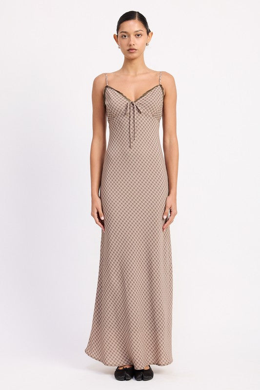 the dress is a form-fitting, floor-length maxi with a soft, neutral taupe color and a delicate, textured fabric