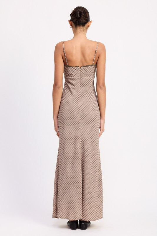 the dress is a form-fitting, floor-length maxi with a soft, neutral taupe color and a delicate, textured fabric
