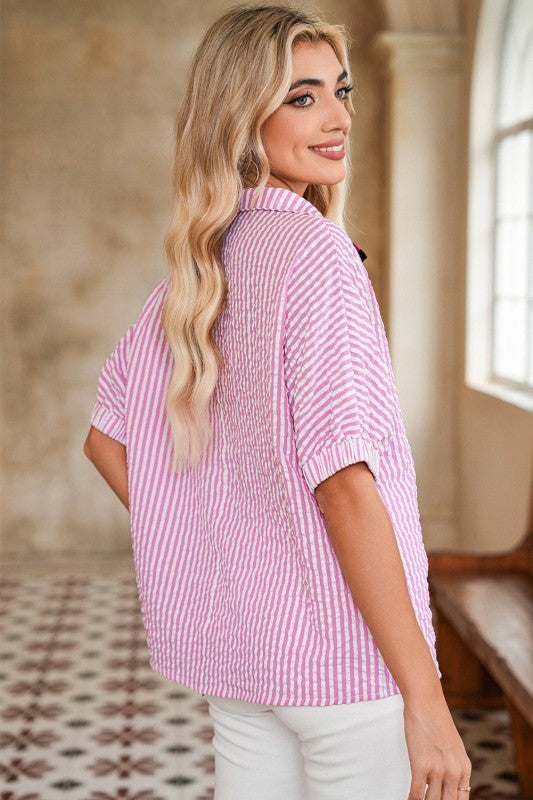 Collar neckline balances the flowy sleeves with structure.