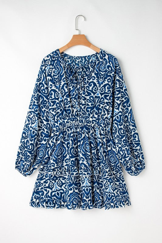 A boho-lace-up v-neck dress hanging in a white background.