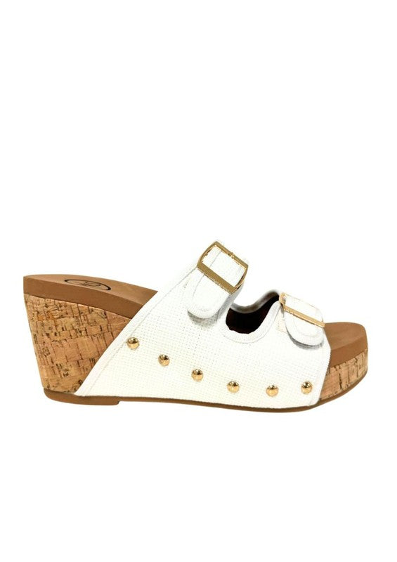 Platform wedge sandals with dual buckle straps, studded detail, open-toe design, cork wedge heel, and slip-on style