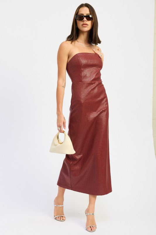 A woman models a sleek, strapless midi dress with a textured finish, ideal for a chic evening look, in a motion pose.