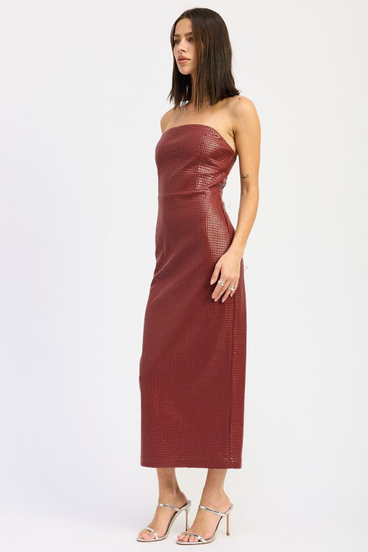 A woman models a sleek, strapless midi dress with a textured finish, ideal for a chic evening look, side view.