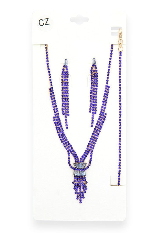 Jewelry set featuring a V-shaped necklace, matching earrings, and bracelet adorned with vibrant blue gemstones set in gold-toned metal—striking, symmetrical, and ideal for formal or festive occasions.
