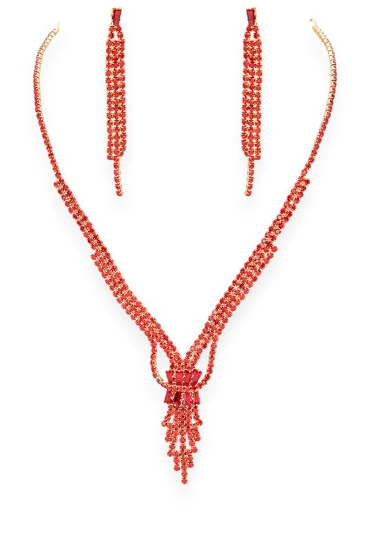 Jewelry set featuring a V-shaped necklace, matching earrings, and bracelet adorned with vibrant red gemstones set in gold-toned metal—striking, symmetrical, and ideal for formal or festive occasions.