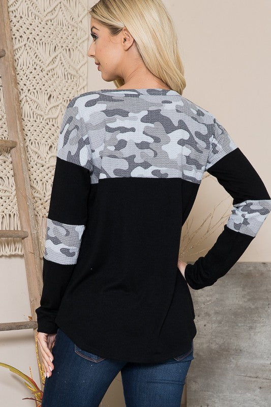 The camouflage pattern contrasts beautifully against solid knit sections.