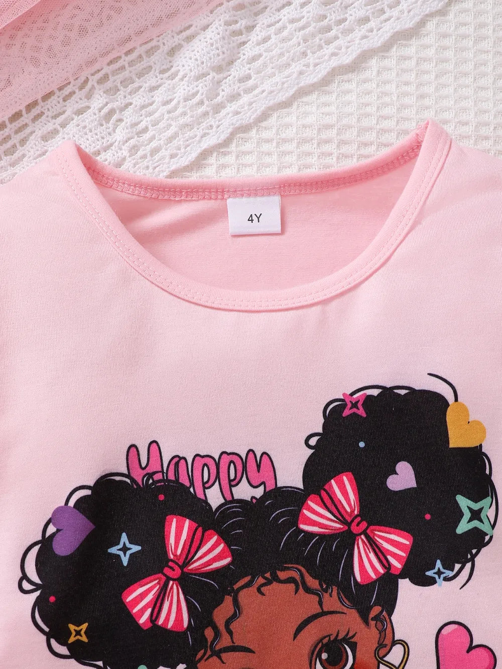 Children’s two-piece outfit with cartoon print top and matching pants, soft knit fabric for comfort and movement