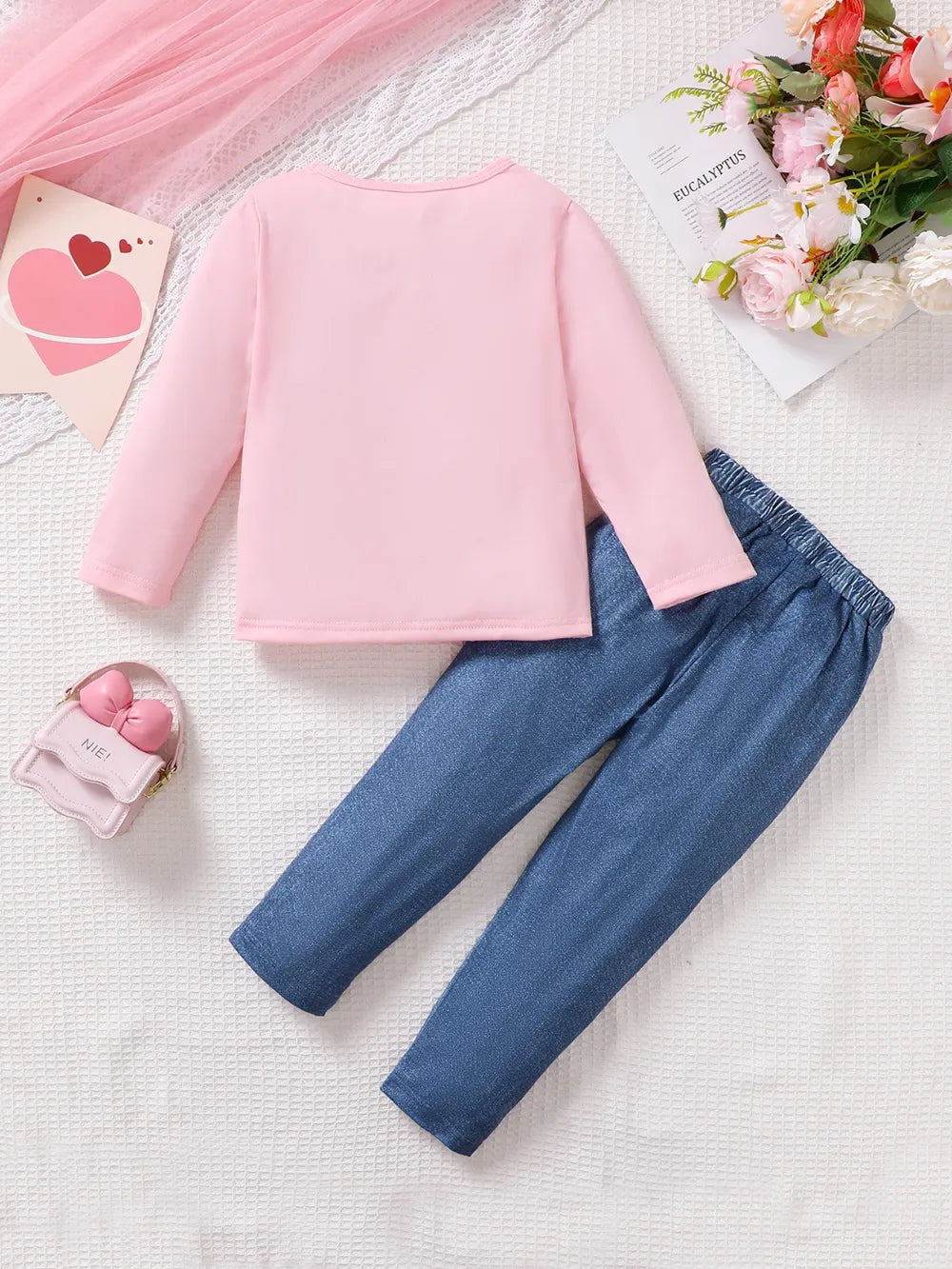 Children’s two-piece outfit with cartoon print top and matching pants, soft knit fabric for comfort and movement
