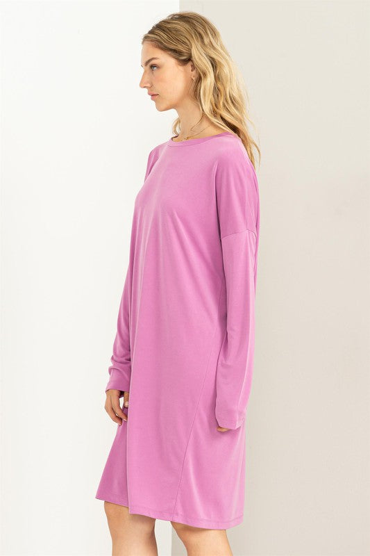 A woman models a comfortable, oversized Midi Dress with a relaxed fit, perfect for casual wear, side view.