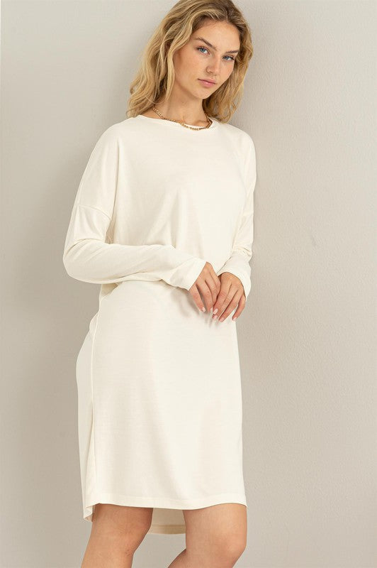 A woman models a white, comfortable oversized Midi Dress with a relaxed fit, perfect for casual wear.