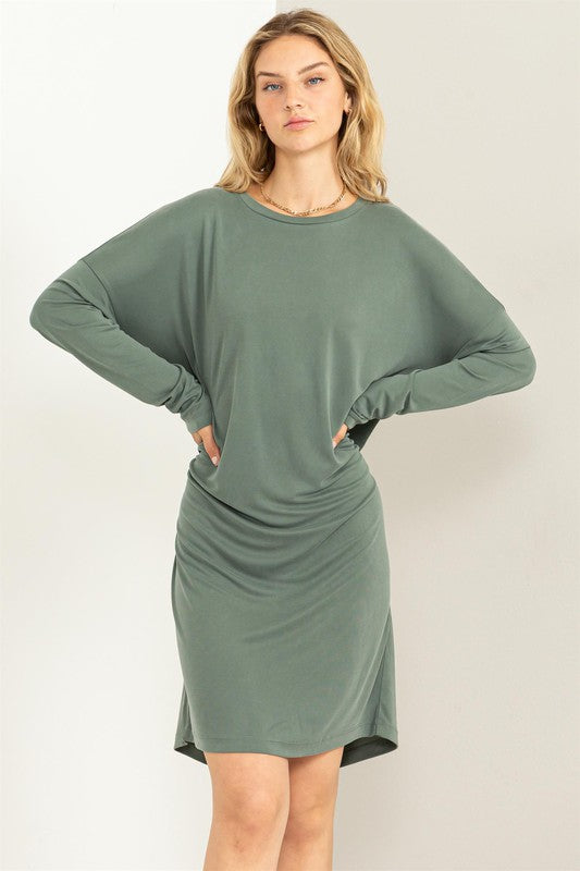 A woman models a comfortable, oversized Midi Dress with a relaxed fit, perfect for casual wear, posing with hands on waist.
