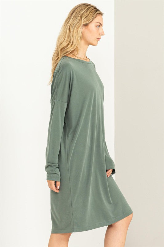 A woman models a comfortable, oversized Midi Dress with a relaxed fit, perfect for casual wear, side facing view.