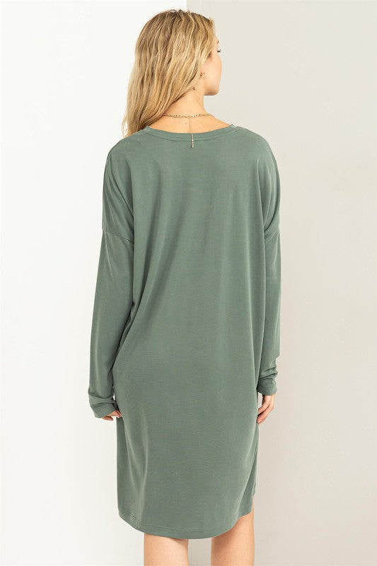A woman models a comfortable, oversized Midi Dress with a relaxed fit, perfect for casual wear, back view with head tilted slightly.