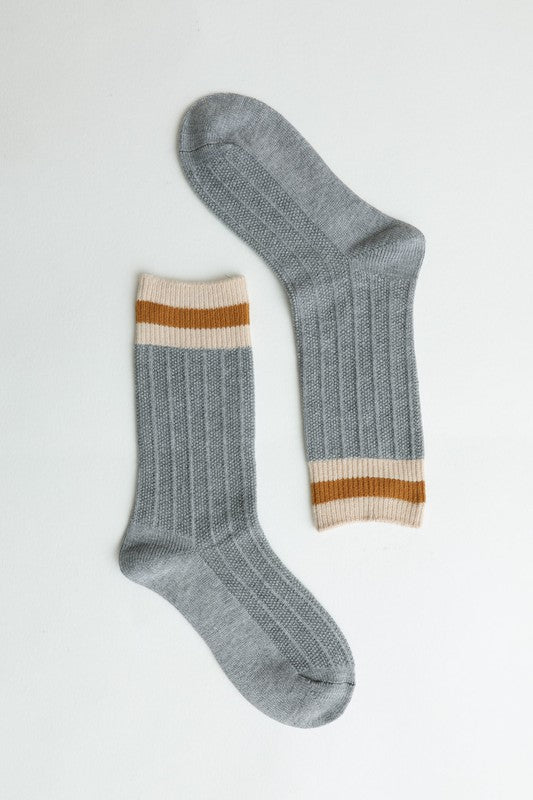 Grey ribbed crew socks with striped cuffs for comfortable use.