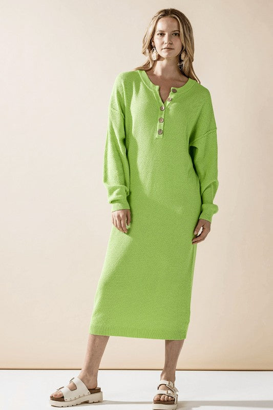 Woman wearing a button-front sweater midi dress with long sleeves and henley neckline.
