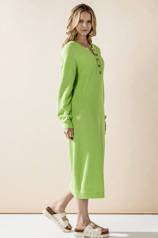 Woman wearing a button-front sweater midi dress with long sleeves and henley neckline.