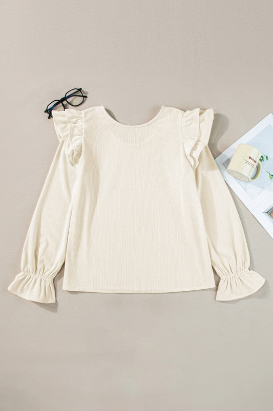Features elegant ruffled flounce sleeves for a feminine touch.