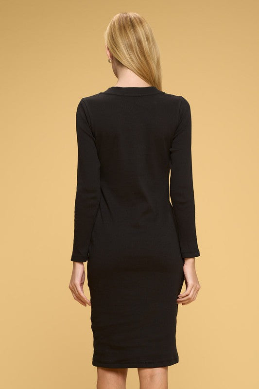 Black dress worn by a person on a beige background