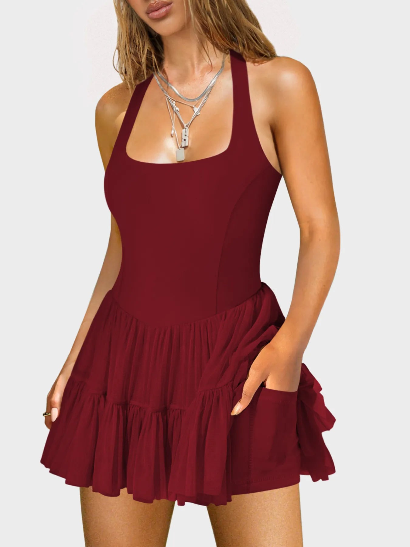 Mini dress with square neckline and crisscross back straps, fitted silhouette — stylish and eye-catching for evening wear or parties