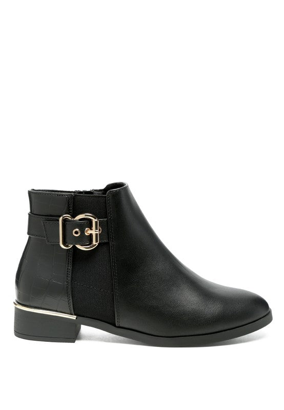A decorative strap with a gold-tone buckle runs around the outer side near the ankle.