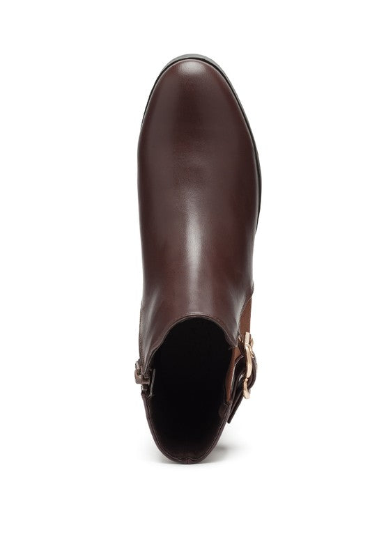 A brown decorative strap with a gold-tone buckle runs around the outer side near the ankle.