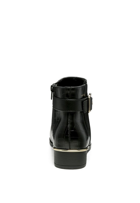 A decorative strap with a gold-tone buckle runs around the outer side near the ankle.