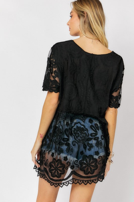The round neck frames the face beautifully while the crochet draws the eye inward.