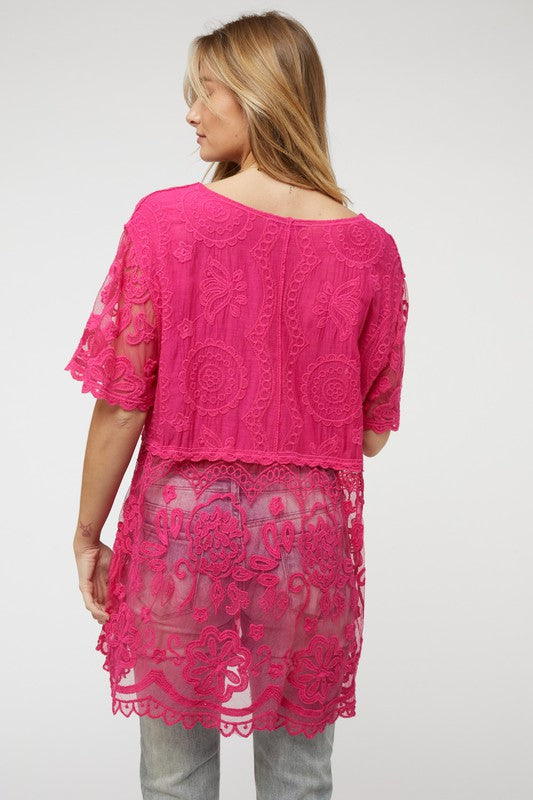 Romantic crochet layers paired with functional buttons make this top a standout.