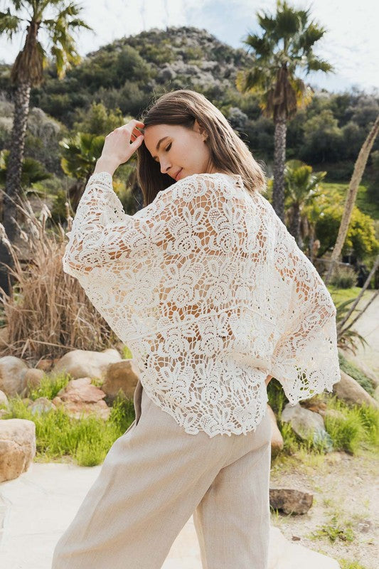 Lightweight crochet wrap that layers beautifully over tanks, dresses, or swimsuits.