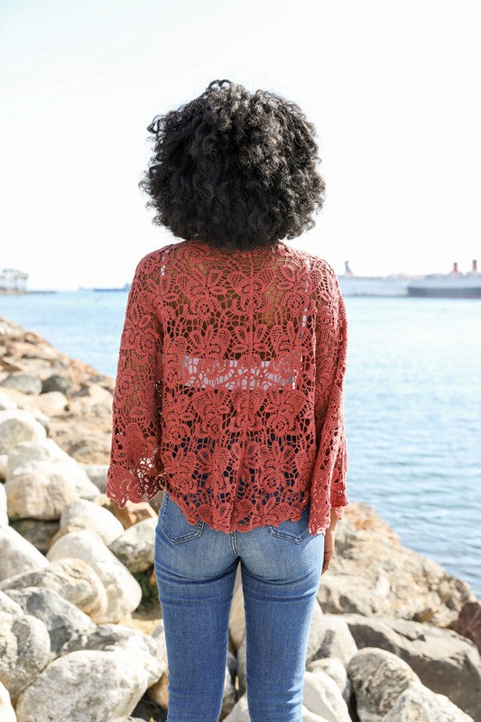 The petal crochet detail frames the silhouette with delicate artistry.