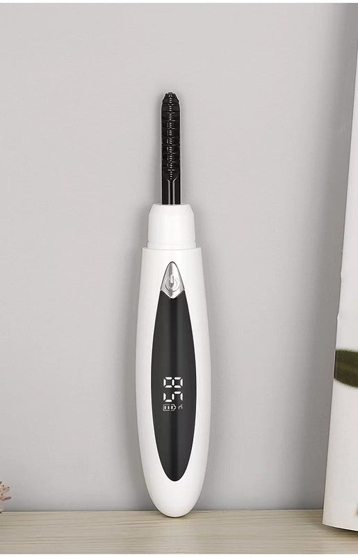 Electric eyelash curler with ergonomic design and USB charging port, ideal for achieving natural-looking curls.