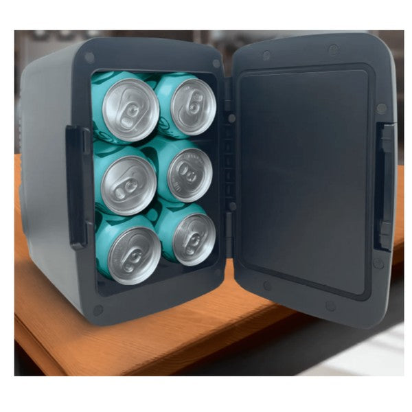 Open black mini fridge on a wooden surface, holding six yellow-and-silver cans—set in a room with guitars and equipment visible in the blurred background.