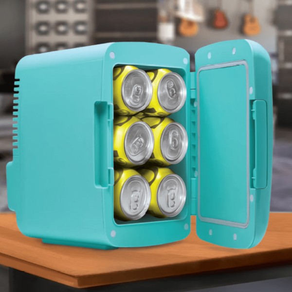 Open turquoise mini fridge on a wooden surface, holding six yellow-and-silver cans—set in a room with guitars and equipment visible in the blurred background.