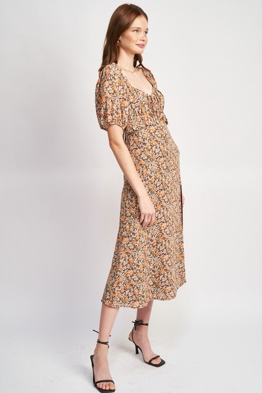 Woman models a chic floral midi dress with puff sleeves, a sweetheart neckline, and a trendy high slit, perfect for spring/summer, side view.