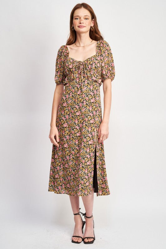 Woman models a chic floral midi dress with puff sleeves, a sweetheart neckline, and a trendy high slit, perfect for spring/summer, full front view.