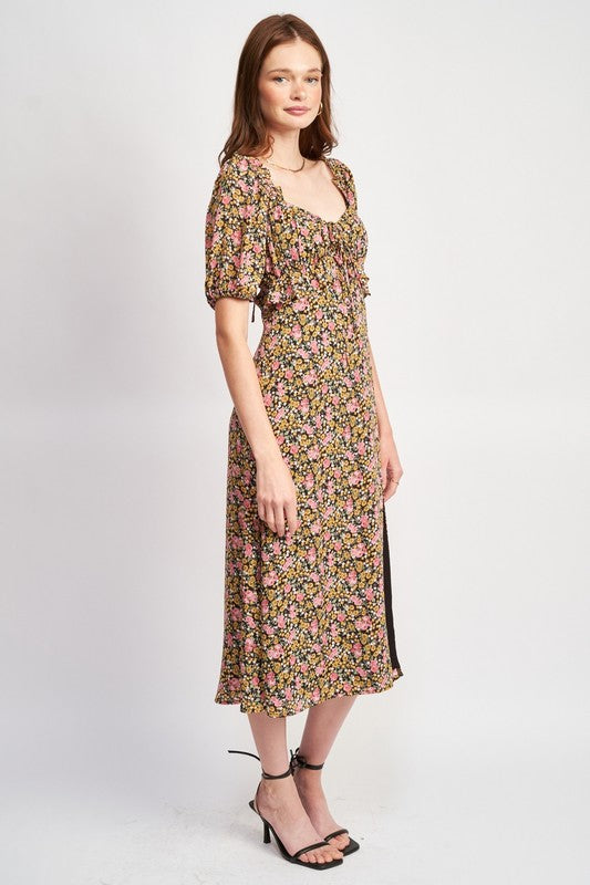 Woman models a chic floral midi dress with puff sleeves, a sweetheart neckline, and a trendy high slit, perfect for spring/summer, full side view.