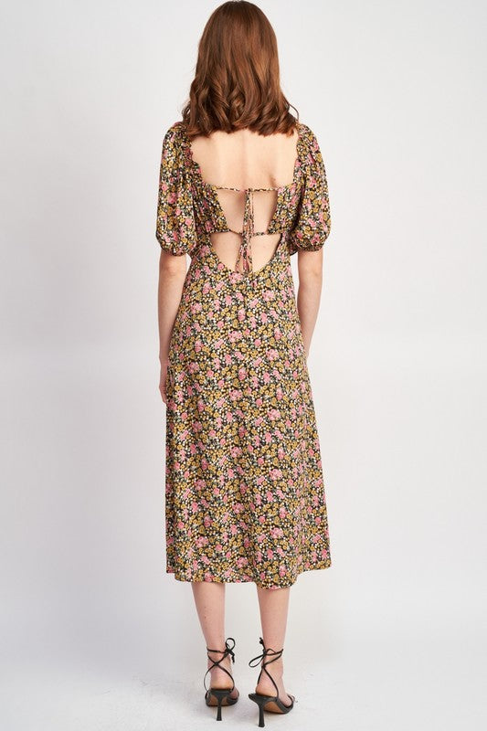 Woman models a chic floral midi dress with puff sleeves, a sweetheart neckline, and a trendy high slit, perfect for spring/summer, full back view.